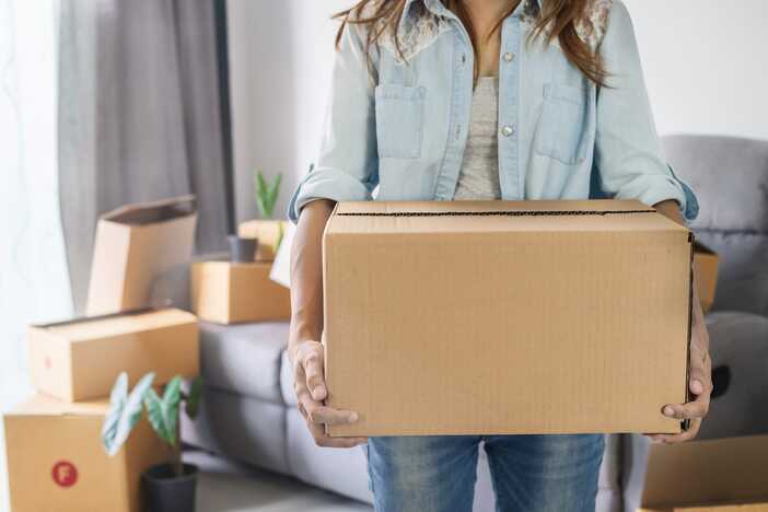 A Person moving Boxes As Part Of A Move To A New City